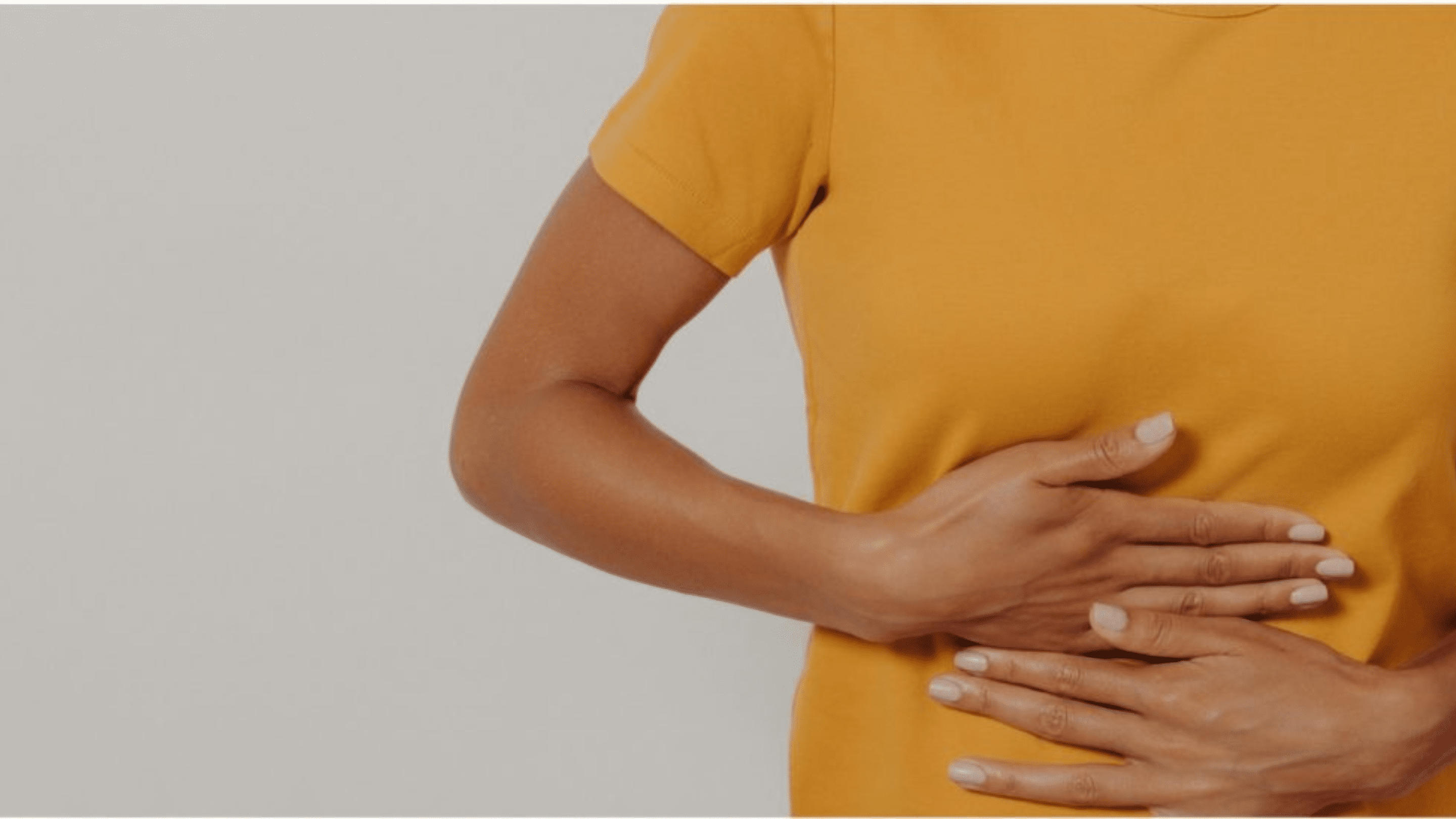Woman holding her hands on her abdomen