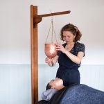 Anu Paavola, Ayurvedic practitioner, giving a shirodhara and Indian head massage at her ayurveda retreat in Dorset UK.