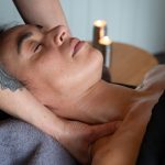 hand doing upper neck massage