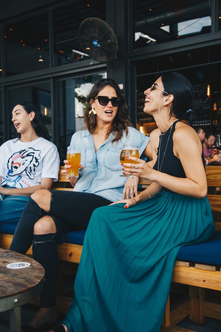 Two happy women enjoying a relaxing drink on holiday