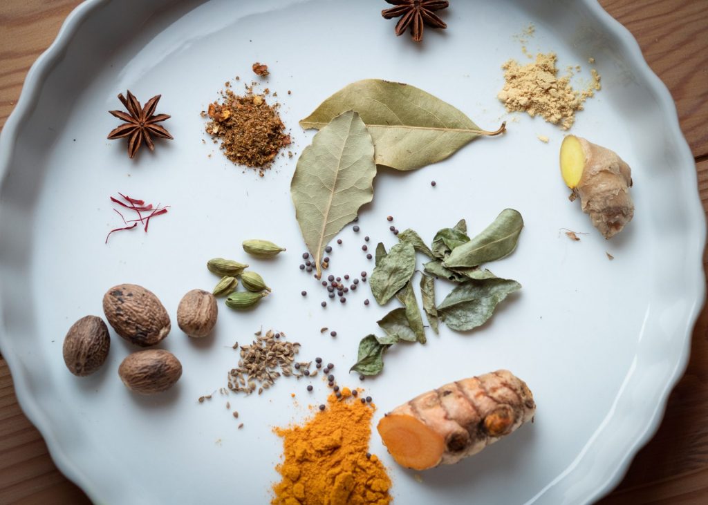 Ayurvedic herbs and spices scattered on a plate