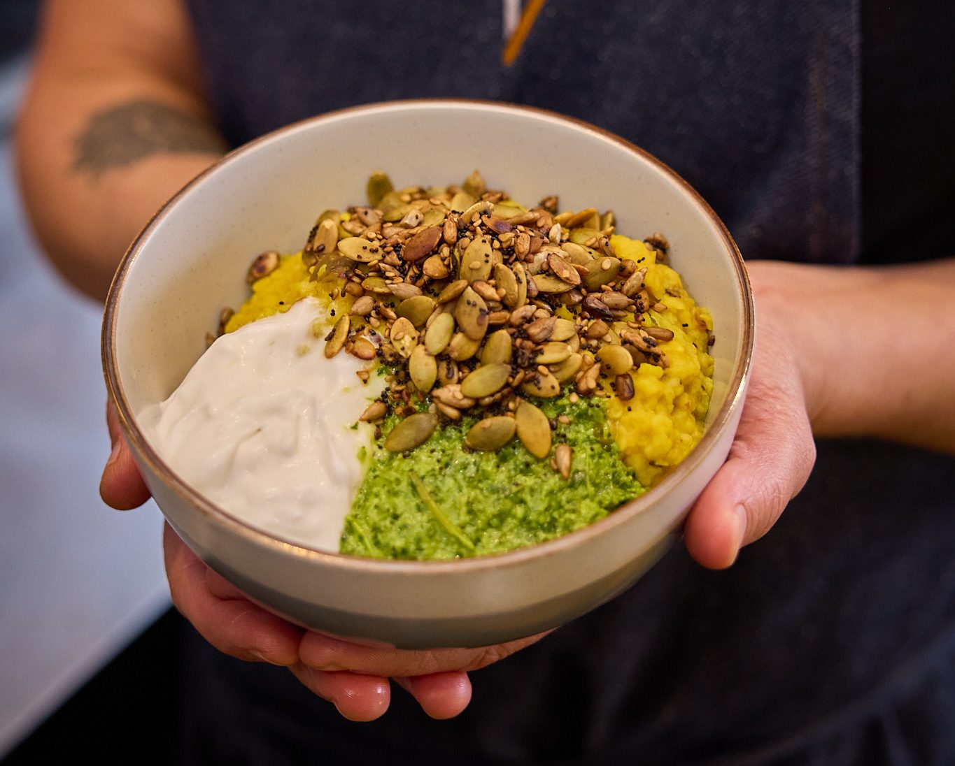 Hands holding a bowl of kitchari