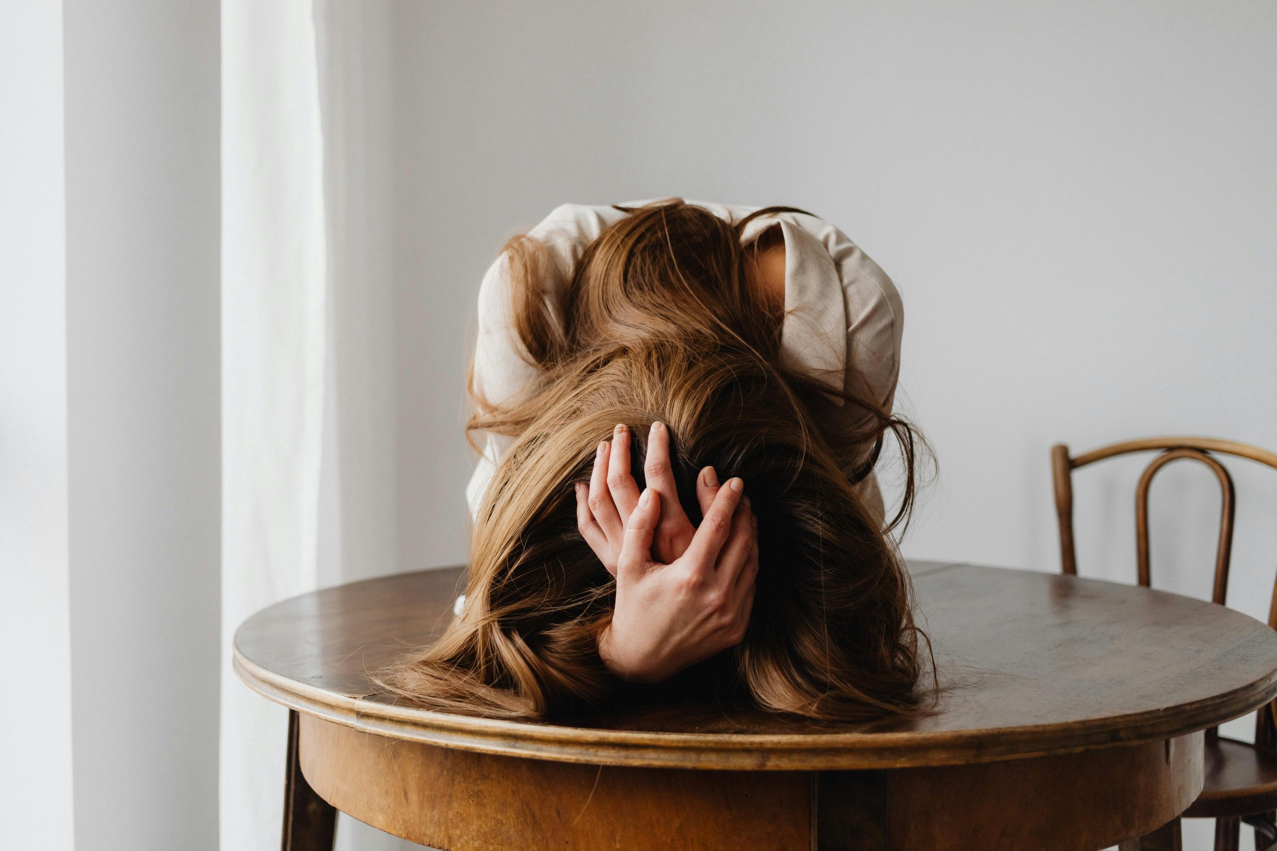 woman holding her migraine head